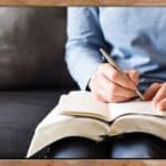 Have a prayer list - why and how at Hope Filled Faith - picture of woman sitting down on couch with pad of paper, pen, and Bible