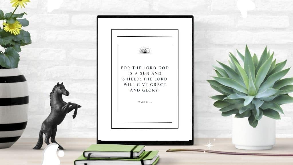 mockup of Psalm 84:11 wall art, on a desk with books, plants, and a horse figurine