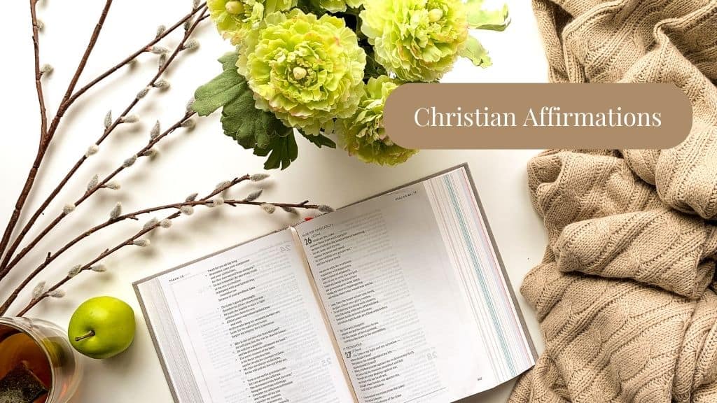 title - Christian Affirmations - with a picture of a cozy blanket, apple, flowers, branches, candle, and an open Bible