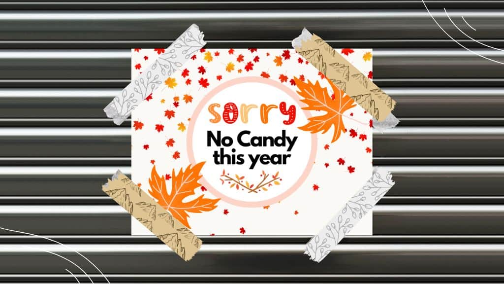 No Candy Halloween Sign printable - picture of fall leaves sign taped up that says sorry no candy this year
