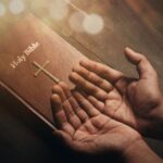1 Easter prayer points with Scriptures praying hands over Bible