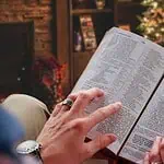 2 - woman reading Bible in front of Christmas tree - Bible verses for December