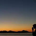 prayer points for a powerful prayer life - woman praying in front of a dusk sky
