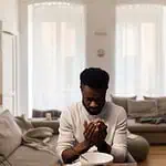 12 - Scriptures to pray for fathers - man praying in living room
