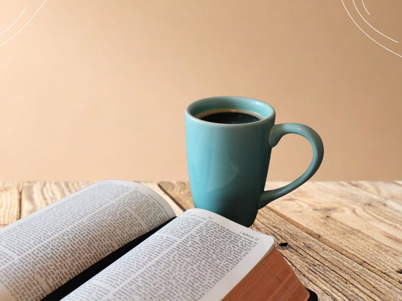 Bible and coffee cup on wooden table